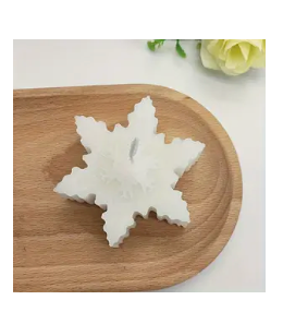 Weihnachtssternförmige Schneeflocken-Aromakerze.